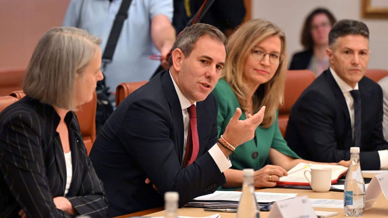 Treasurer Jim Chalmers at a table with others at the summit