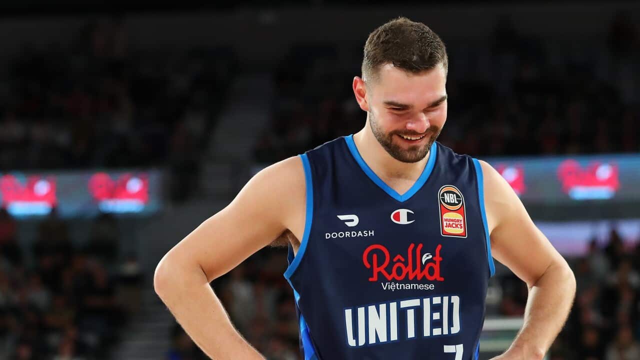 Isaac Humphries smiling on basketball court
