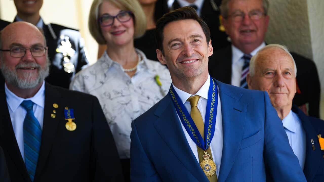 Australian Actor Hugh Jackman poses for photographs with other recipients after he was appointed a Companion in the General Division