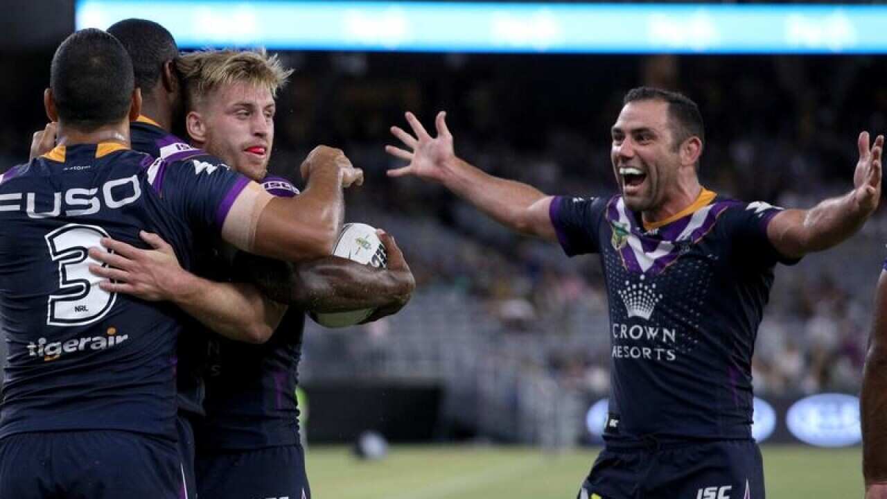 Storm players celebrate a try in Perth