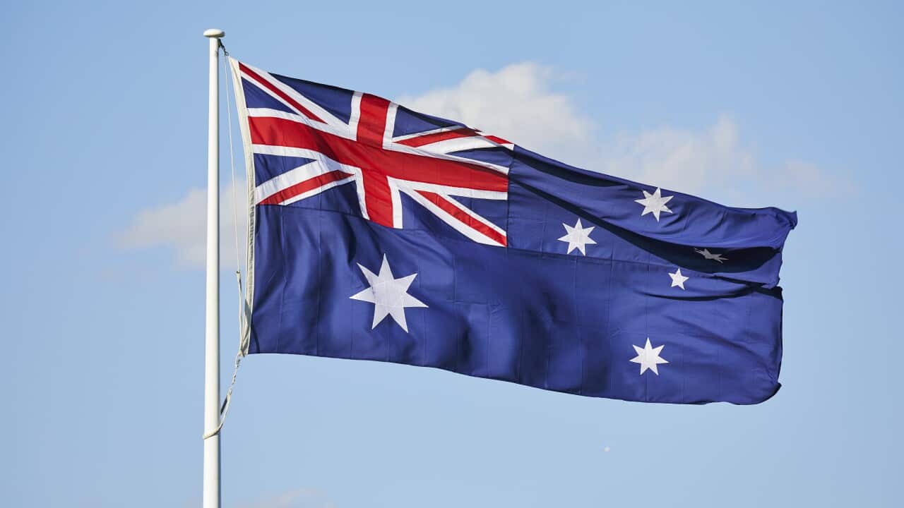 Australian Flag flying in the wind with blue sky/getty