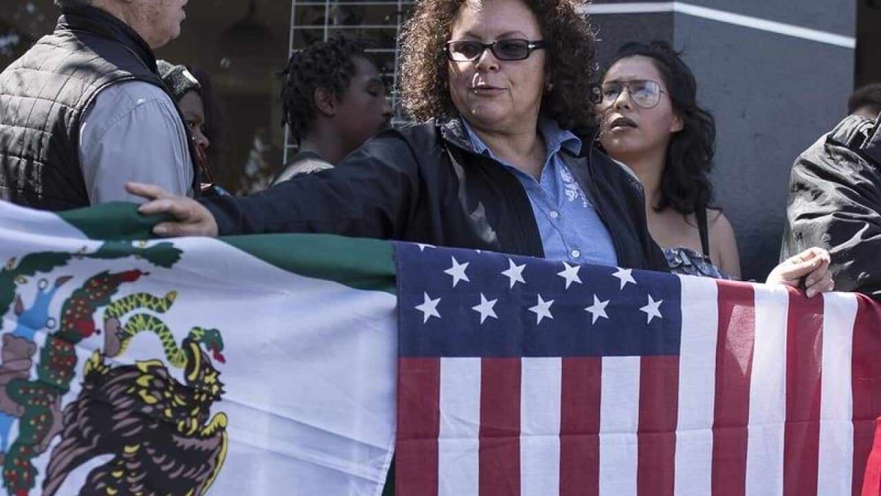 Lilia Lara, a Tijuana resident, displays the U.S. and Mexican flags