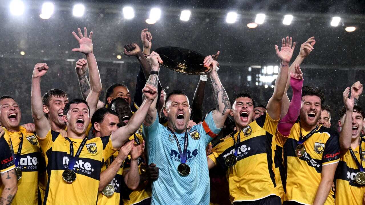 Danny Vukovic and teammates lift the Premiers plate after winning their A-League match between the Central Coast Mariners and Adelaide United