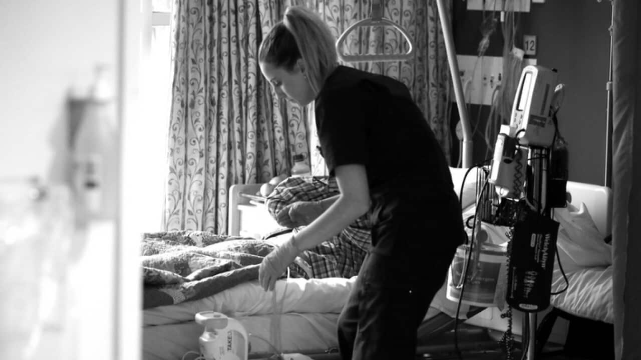 A nurse in a palliative care unit tending to a patient
