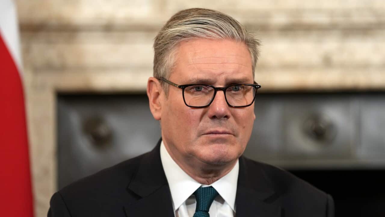 A close up photo of the face of a man in a suit.