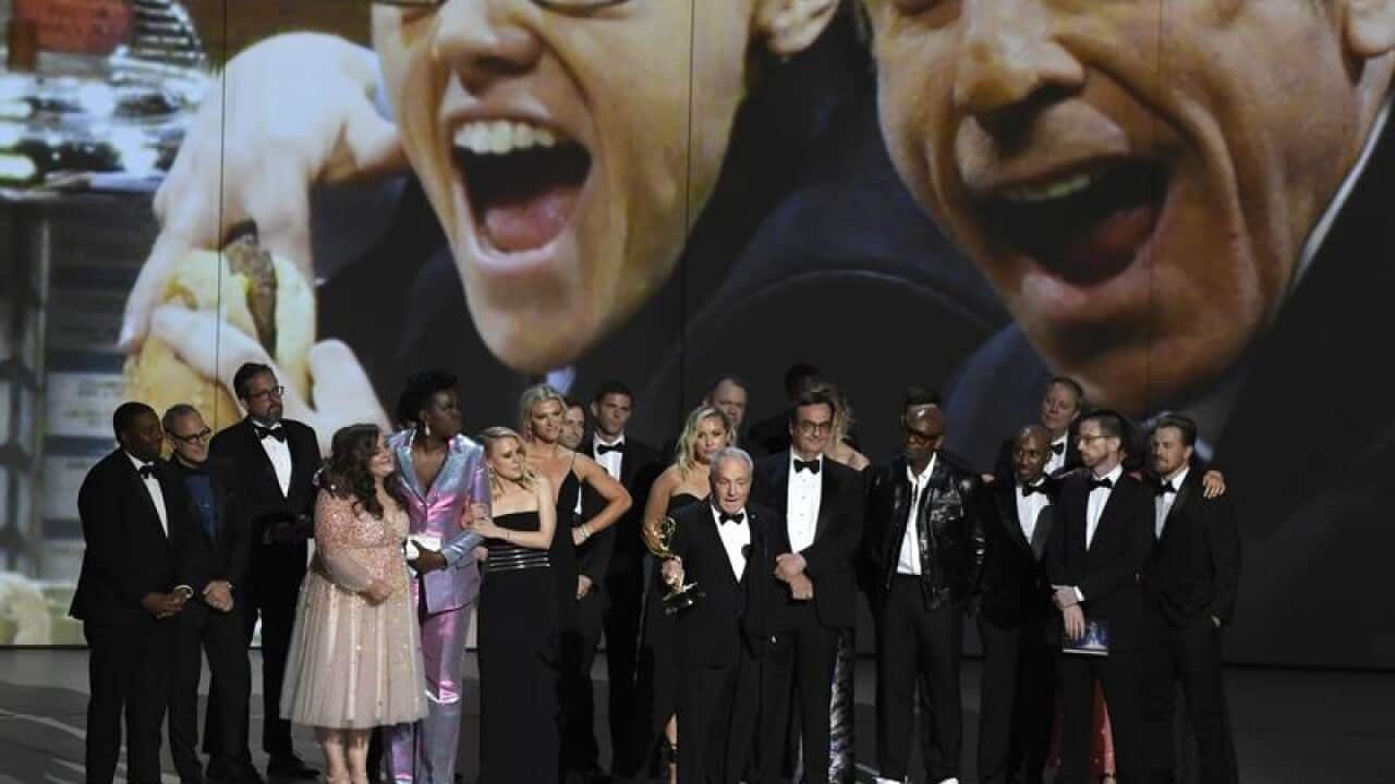 Saturday Night Live accept Emmy award