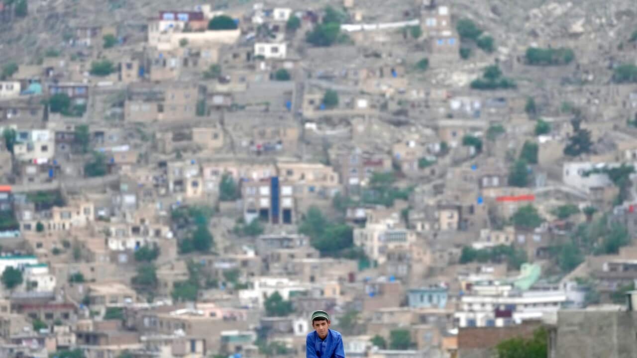 A child sits on the roof of his house in Kabul, Afghanistan.