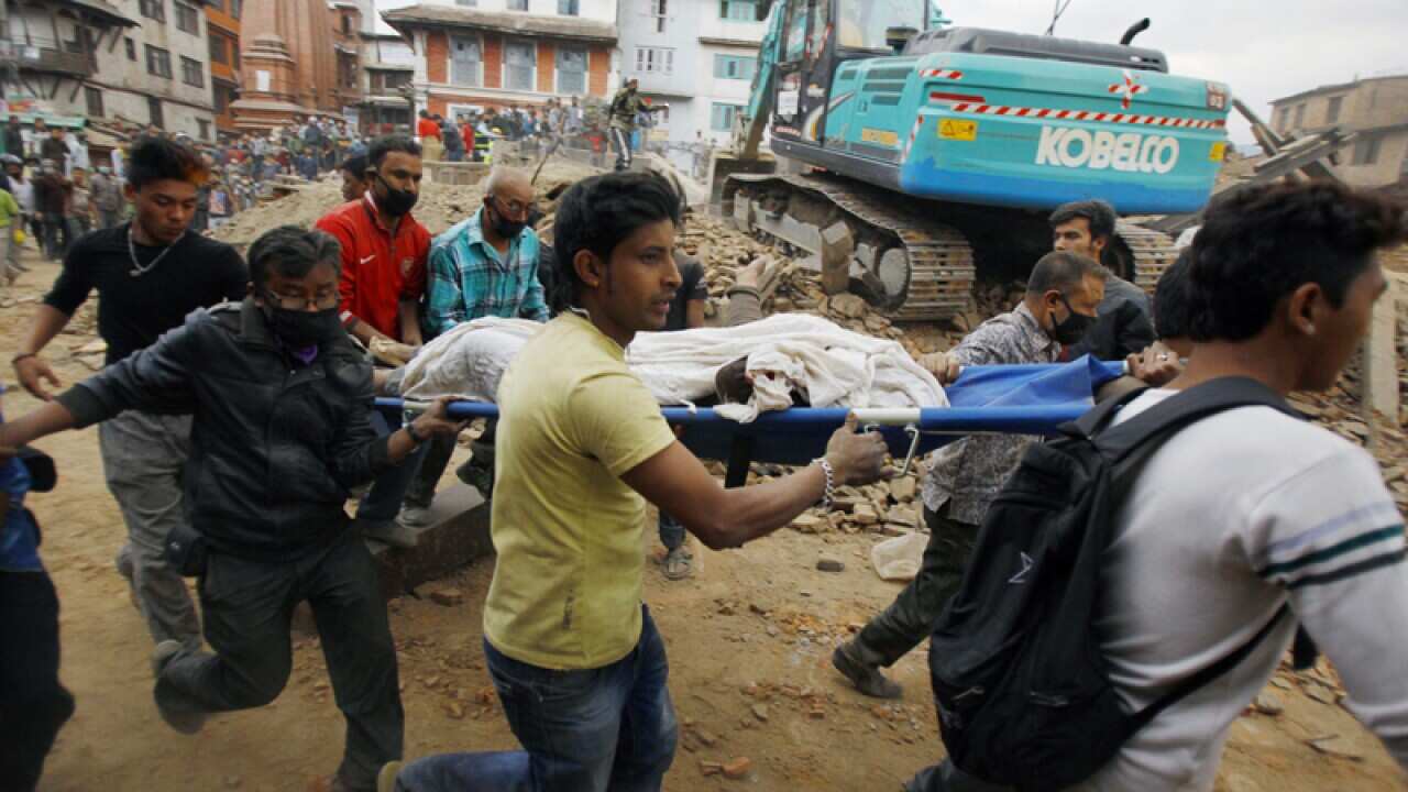 Volunteers carry the body of a victim in Kathmandu