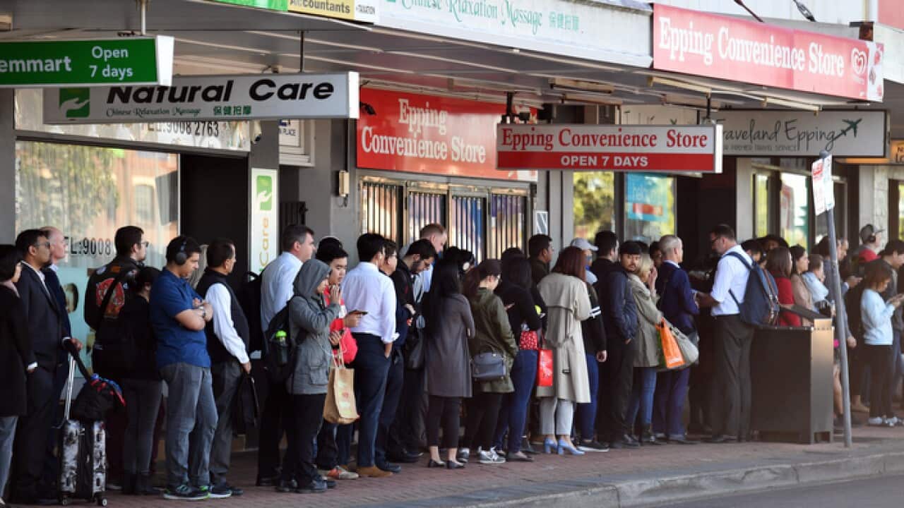 Commuters wait for buses at Epping train station in Sydney
