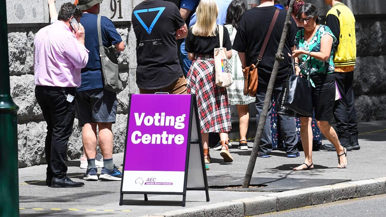 Voters and volunteers are seen at Brisbane City Hall, during early voting for the Indigenous voice to parliament referendum in Brisbane, Tuesday, October 3, 2023.