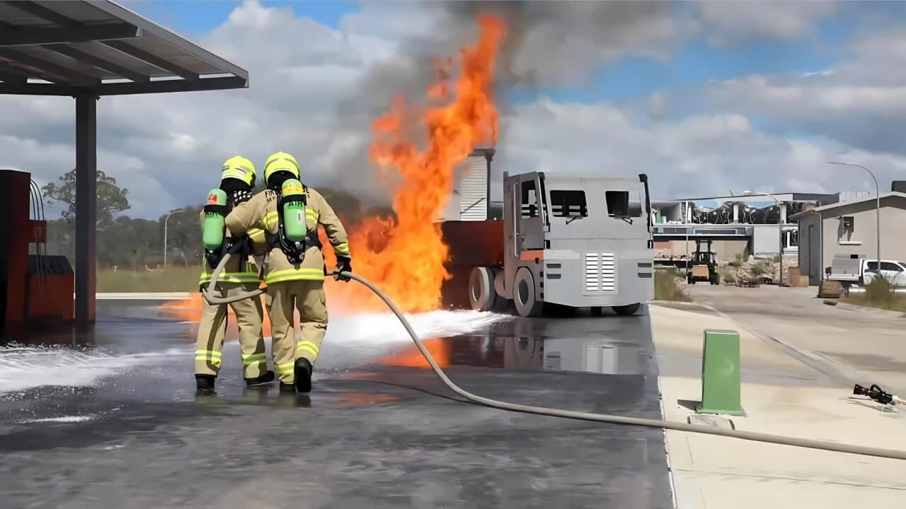 Two young First Nations people tackle a fire in training (SBS).jpg