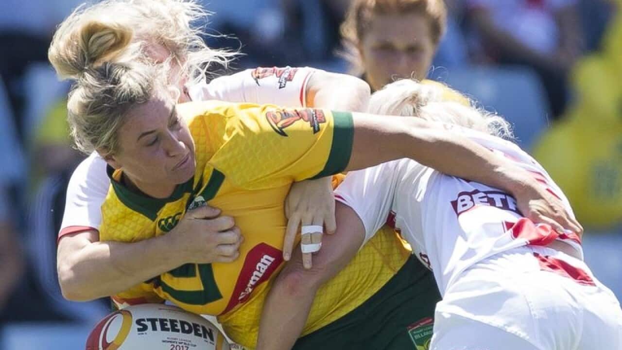 Ruan Sims of Australia is tackled during a game