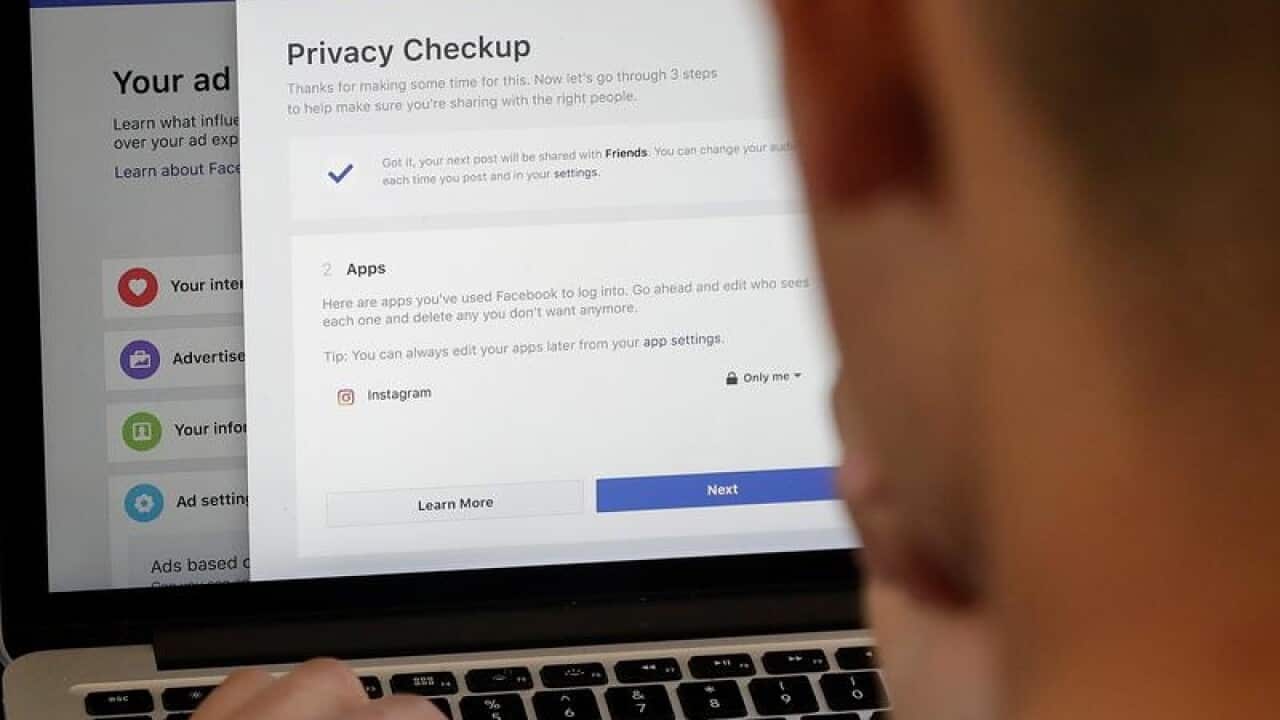 A file photo of a man looking at Facebook ad preferences pages