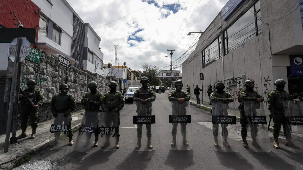 Members of the military guard a street near the Radio Canela station in Quito (AAP)