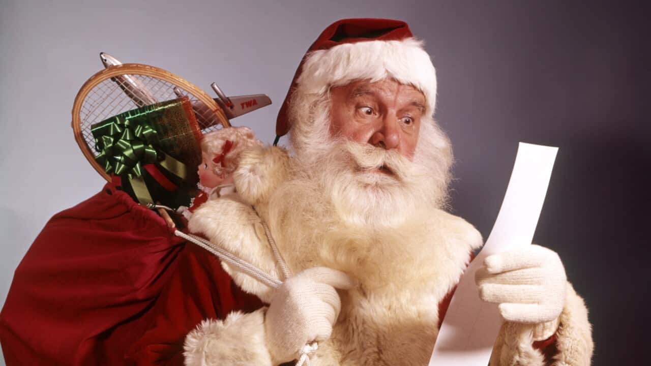  Portrait Of Santa Claus Holding Sack Filled With Toys And Checking His List Naughty Nice Tradition. (Getty)