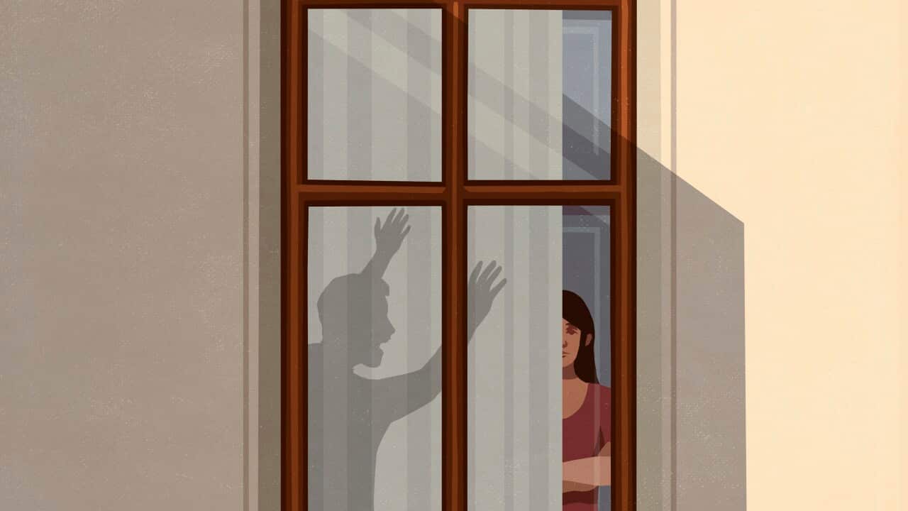 Shadow of angry man gesticulating at woman in apartment window