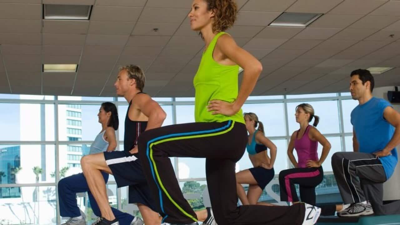 People Exercising in Step Aerobics Class