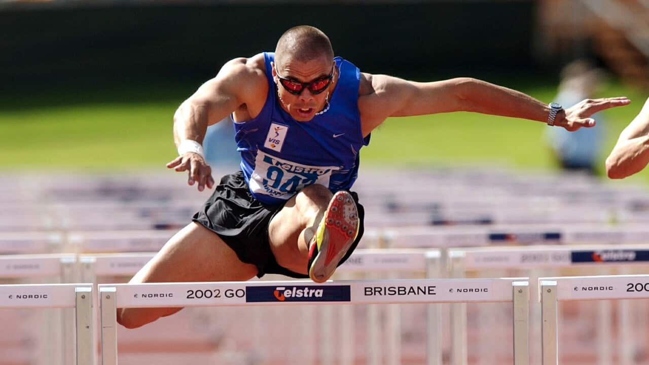 Brisbane, April 14, 2002. Kyle Vander Kuyp during the final of the mens 110m hurdles at the Australian Track and Field Championships in Brisbane today. (AAP Image/Dave Hunt) NO ARCHIVING.