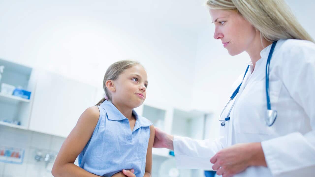 Girl clutching tummy