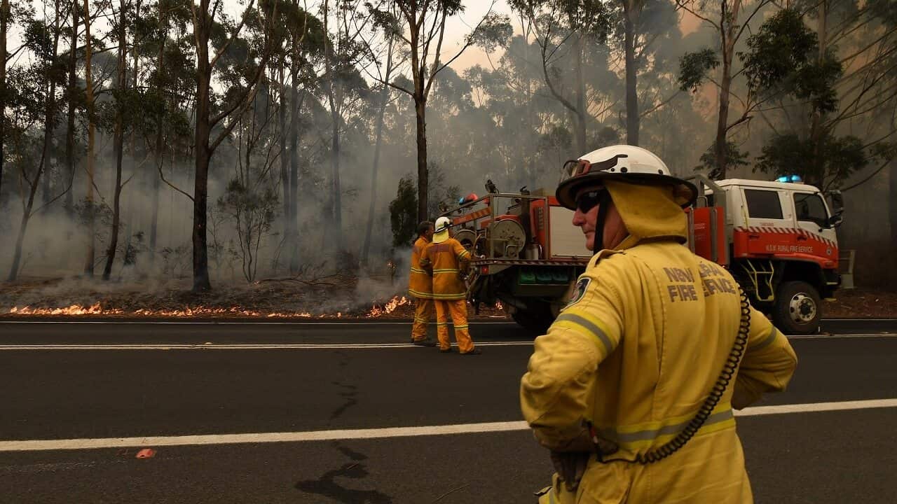 Firefighters contain a small bushfire which closed the Princes Highway south of Ulladulla on Sunday.