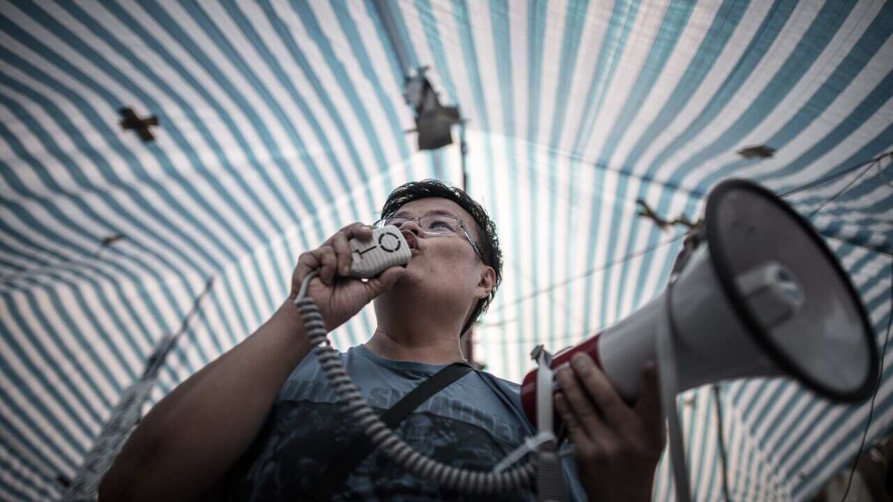 A pro-democracy demonstrator addresses a crowd at a barricade in Hong Kong on October 9, 2014. 