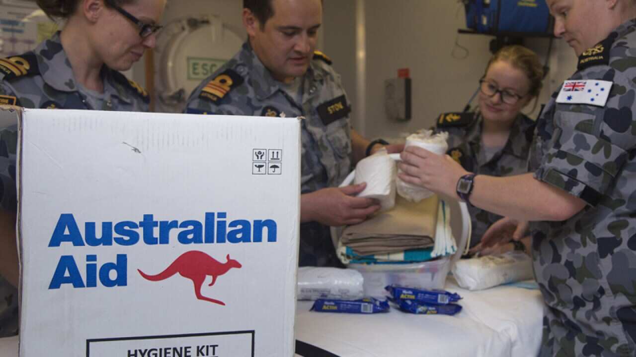 HMAS crew with the contents of the Australian Aid  hygiene kit