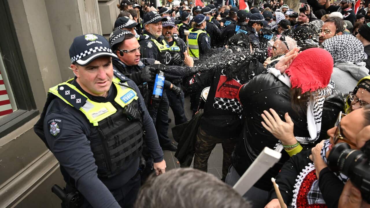 Police deploy pepper spray during a protest.