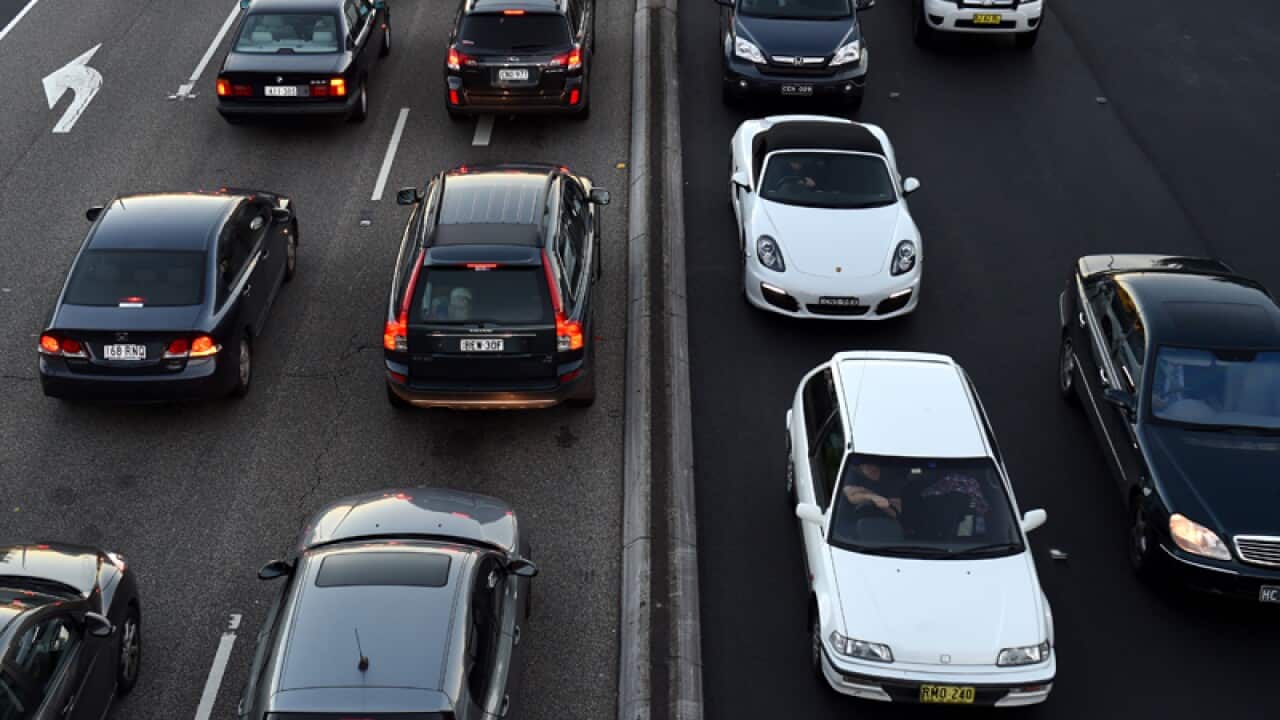 Commuters wait in peak hour traffic.