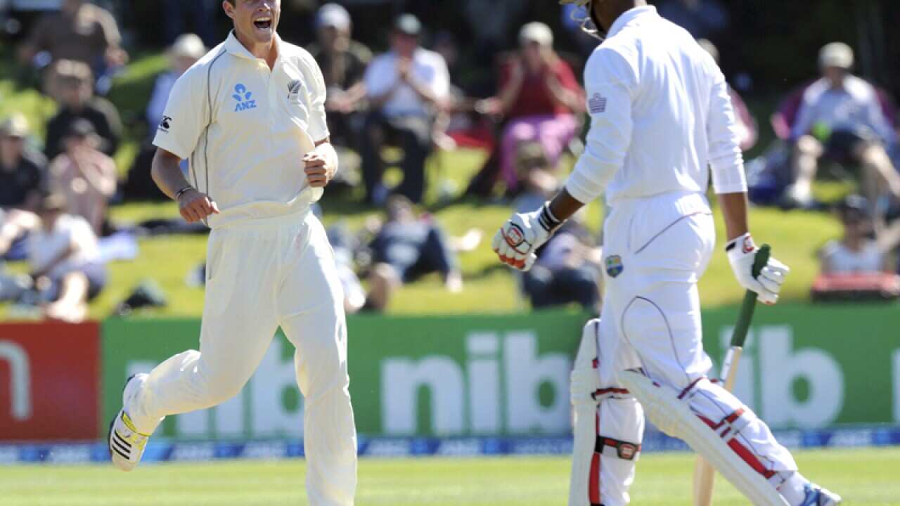 New Zealand's Tim Southee (L) celebrates a wicket