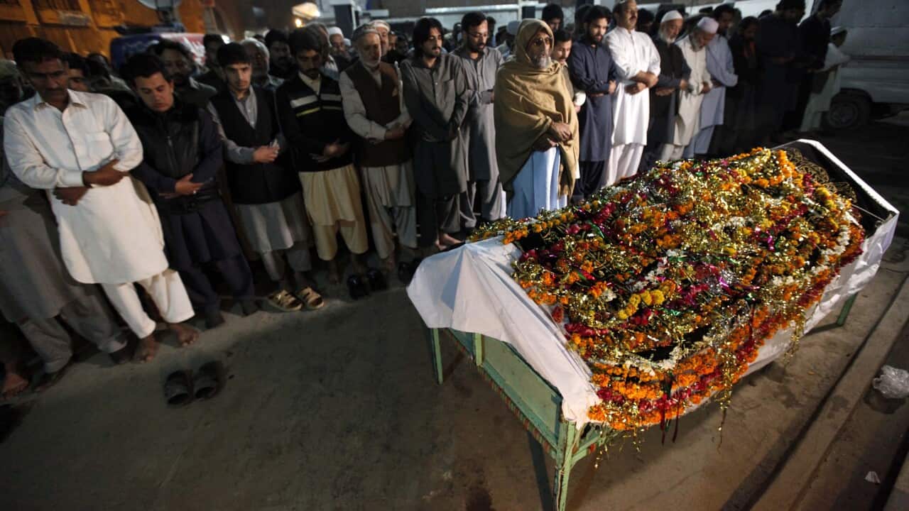 People attend the funeral of a woman who was killed following a 7.7 magnitude earthquake, in Peshawar, Pakistan, 26 October 2015.