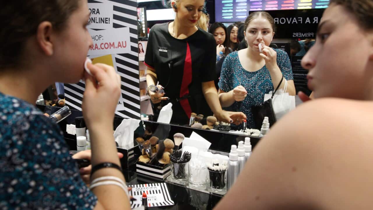 Shoppers test makeup in a Sydney store