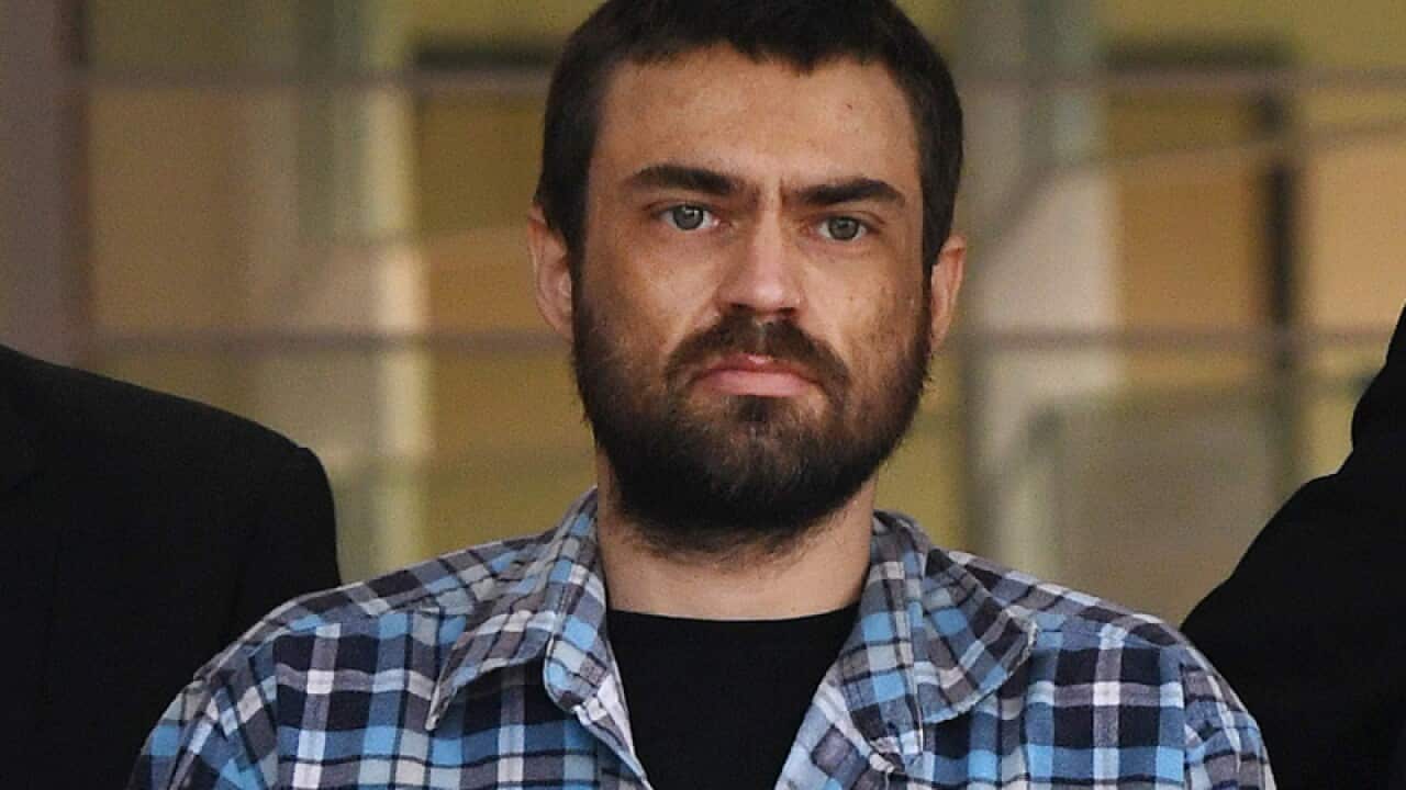 A man is led out of Logan police station