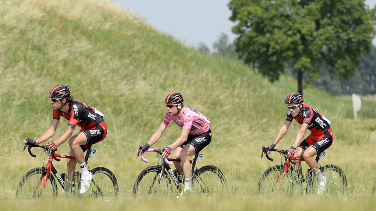 Cadel Evans (2ndL) pedals with his teammates during the Tour of Italy
