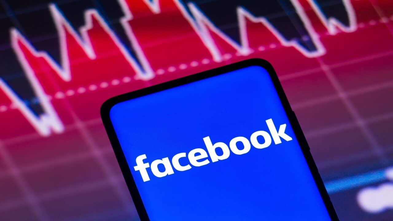 In this photo illustration the Facebook logo seen displayed on a smartphone screen, with graphic representation of the stock market in the background. (Photo by Rafael Henrique / SOPA Images/Sipa USA)