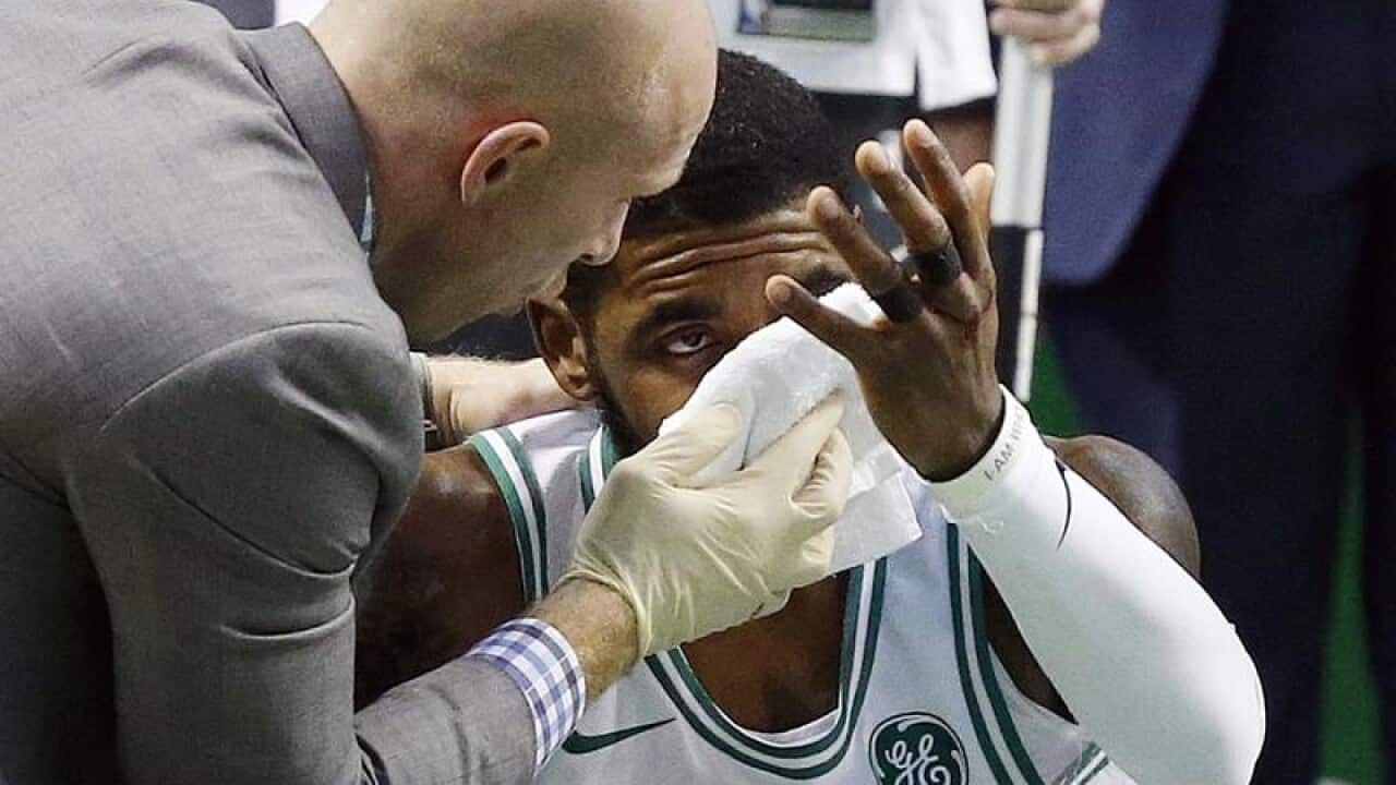 Boston Celtics' Kyrie Irving with a cloth being held to his nose
