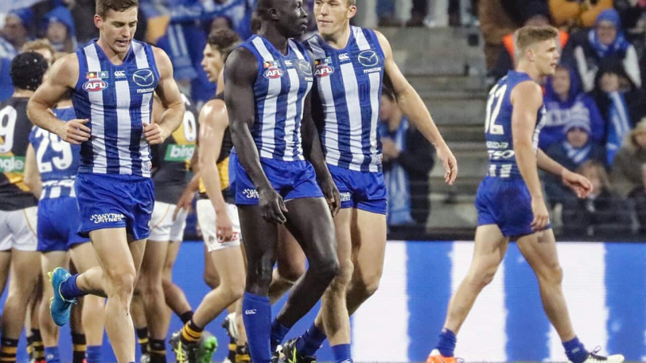 Majak Daw (C) is congratulated after kicking a goal