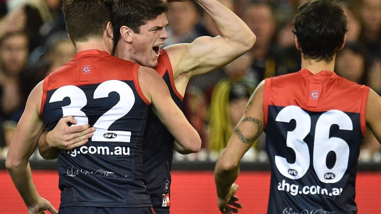 Angus Brayshaw (centre) of the Demons reacts