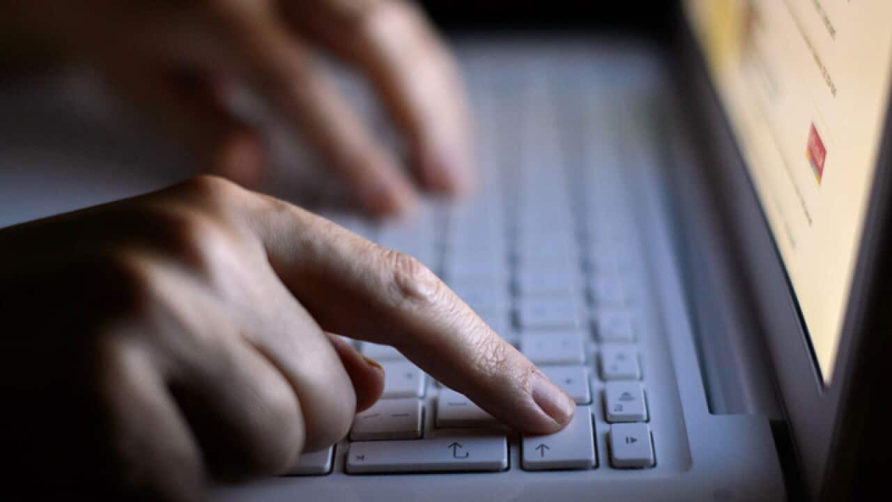 Someone using a laptop keyboard