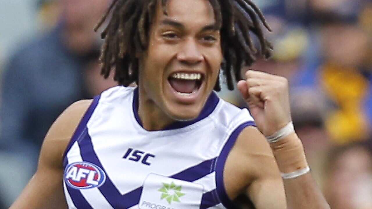 Tendai Mzungu of Fremantle celebrates after kicking a goal