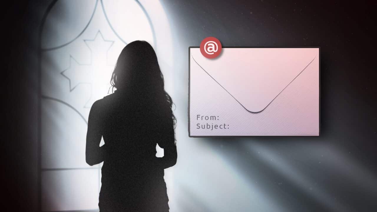 A woman stands near a church window