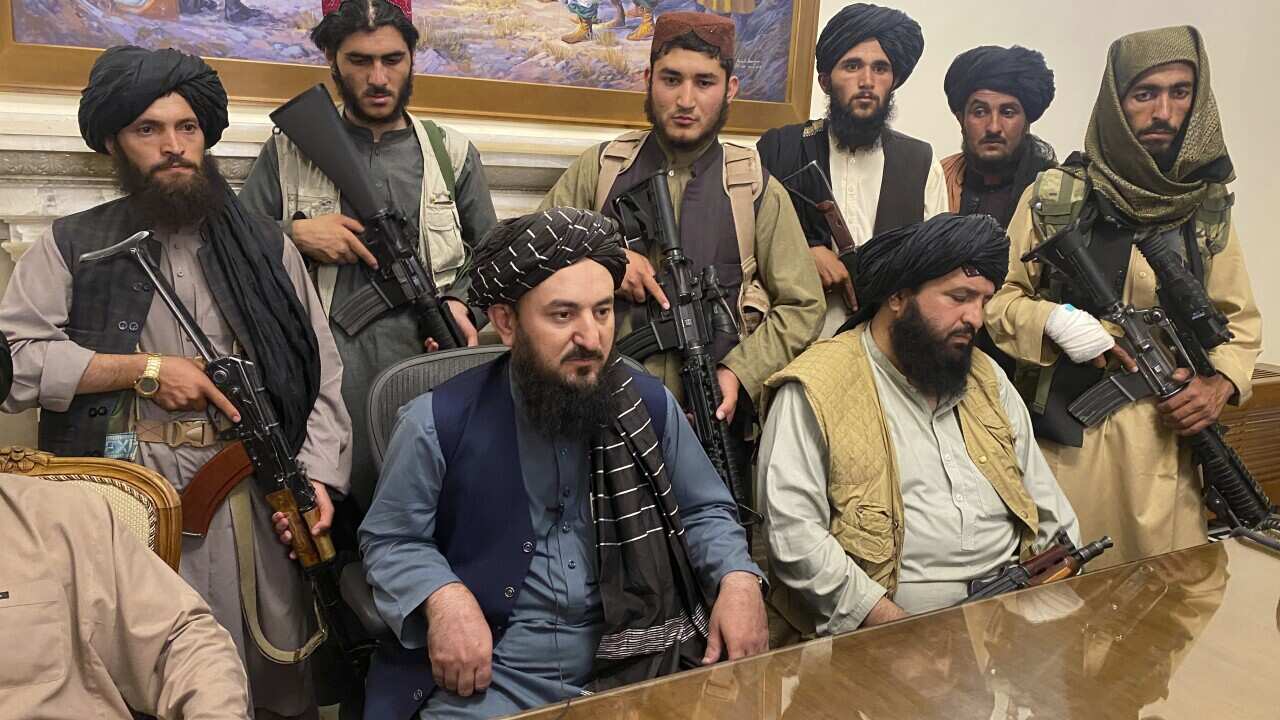 Taliban fighters take control of Afghan presidential palace after the Afghan President Ashraf Ghani fled the country, in Kabul, Afghanistan, Sunday, Aug. 15, 2021. (AP Photo/Zabi Karimi)