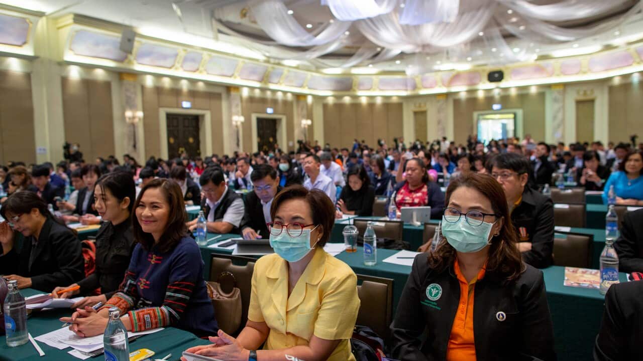 Public health officials participate in a preparation meeting for coronavirus