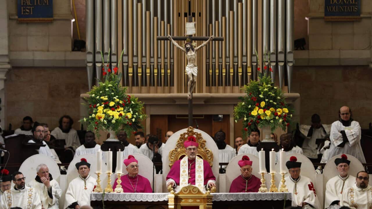 The Apostolic Administrator of Jerusalem, Pierbattista Pizzaballa (C) attends a mass on Christmas Eve inside the Church of the Nativity, in the West bank town of Bethlehem, 24 December 2018 (AAP)