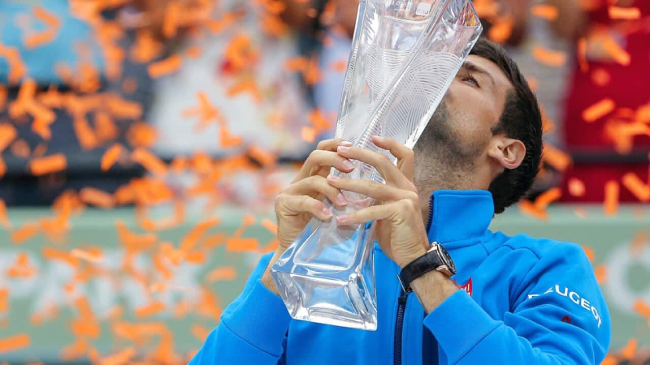 Novak Djokovic of Serbia holds the Butch Buchholz Trophy