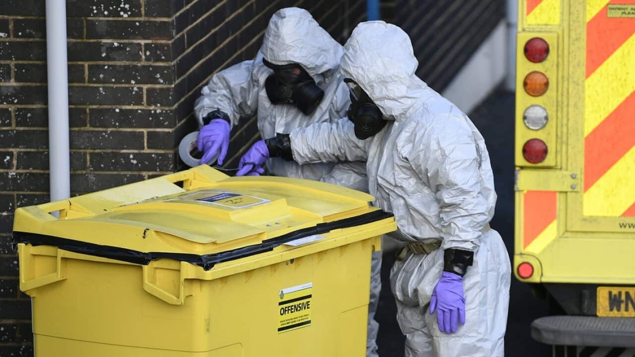 Members of the armed forces examine a bin at the Salisbury ambulance station, as police work their way through 200 witnesses and 240 pieces of evidence.
