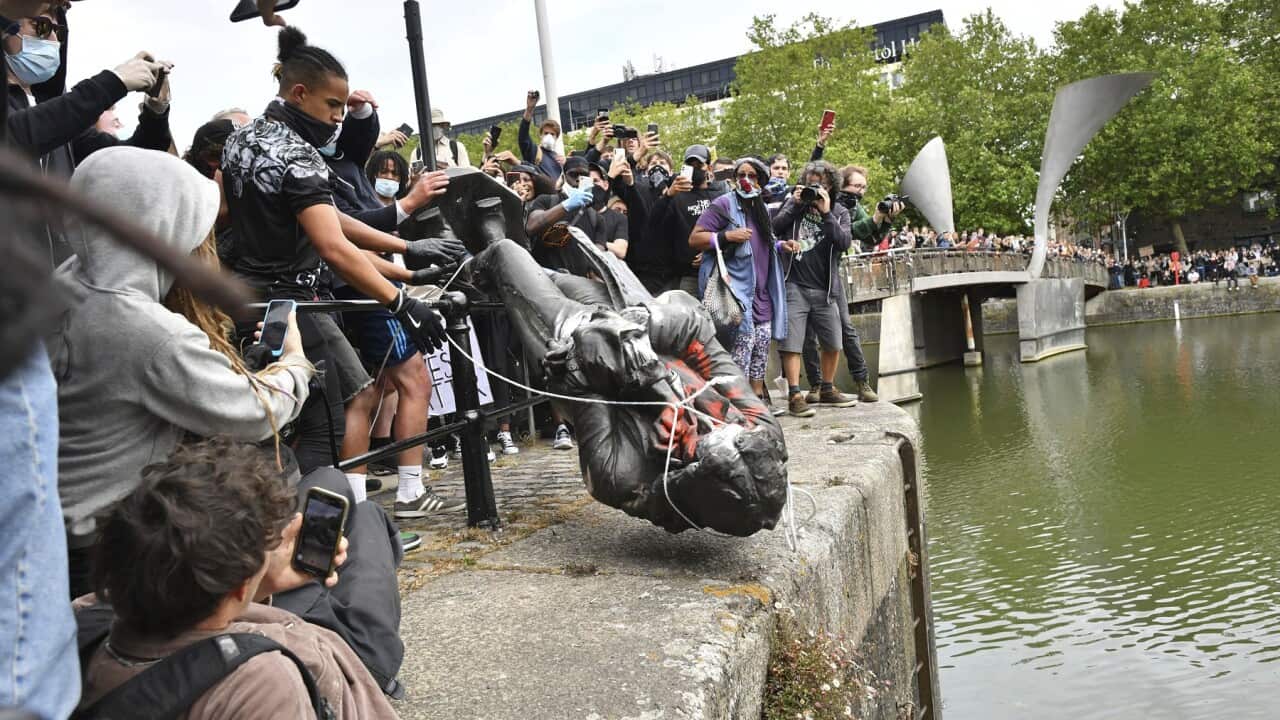 Protesters throw a statue of slave trader Edward Colston into Bristol harbour
