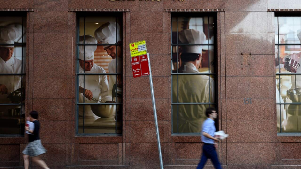 Pedestrians are seen passing the Lindt Cafe at Martin Place, in Sydney