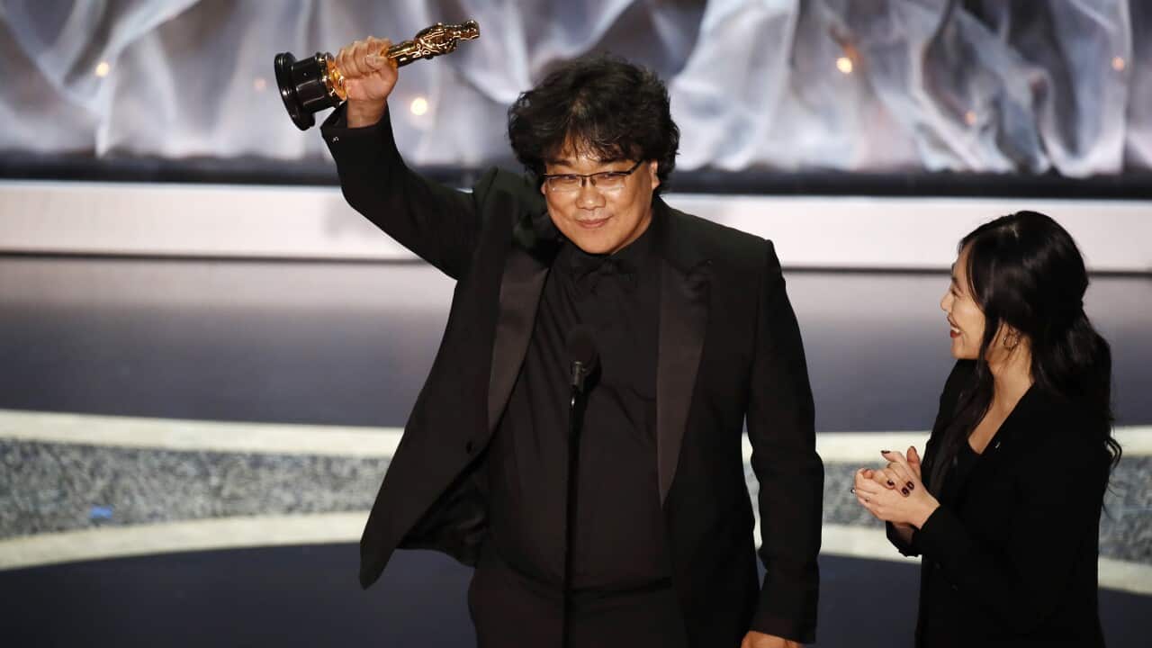 Parasite director Bong Joon-ho accepting one of four Oscars awarded to the South Korean film. 