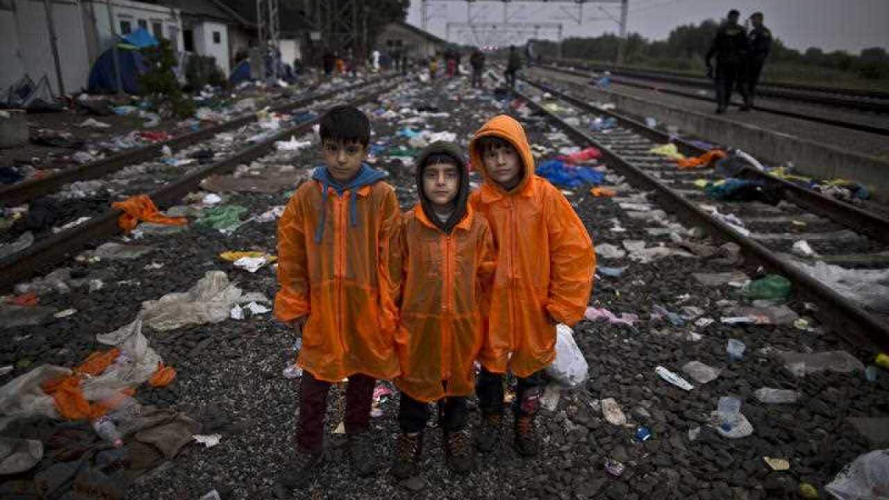 Syrian refugee brothers from right, Sarokan Nasser, 8, Hussam, 6, Ali, 10, pose for a picture while waiting in hope of boarding a train in Croatia. 