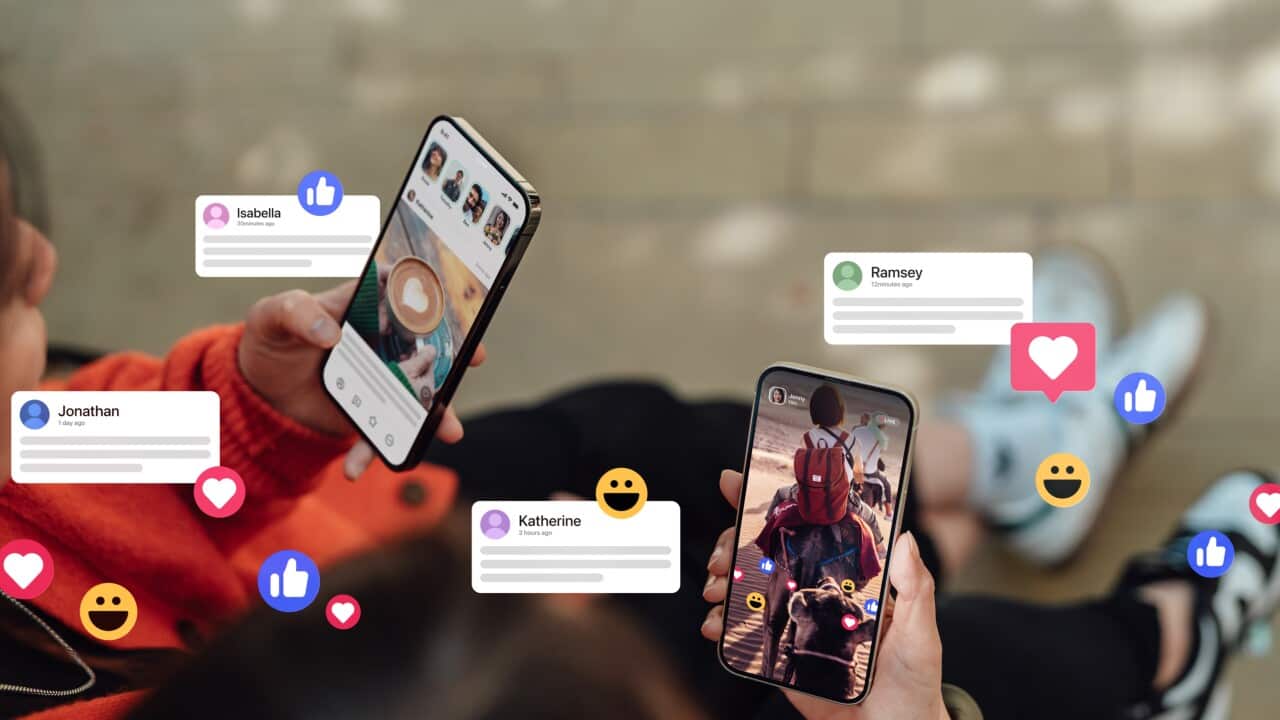 Closeup of two friends commenting and giving likes on social media platform via smartphone